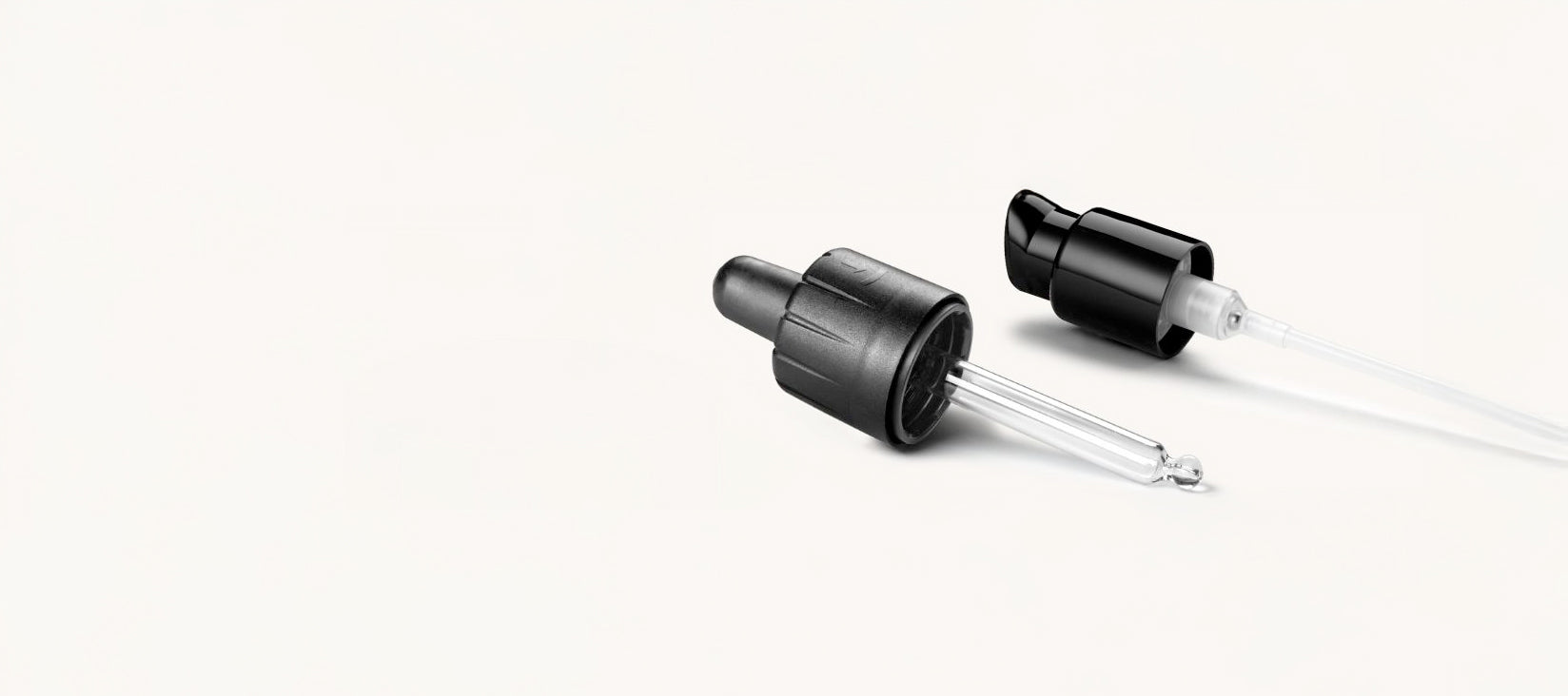 Two black dropper bottles on a white background