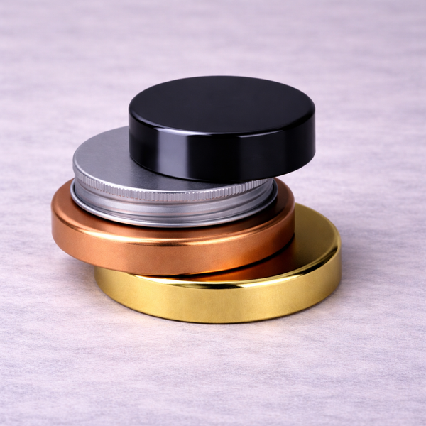 Stack of black, aluminium, copper and gold jar lids
