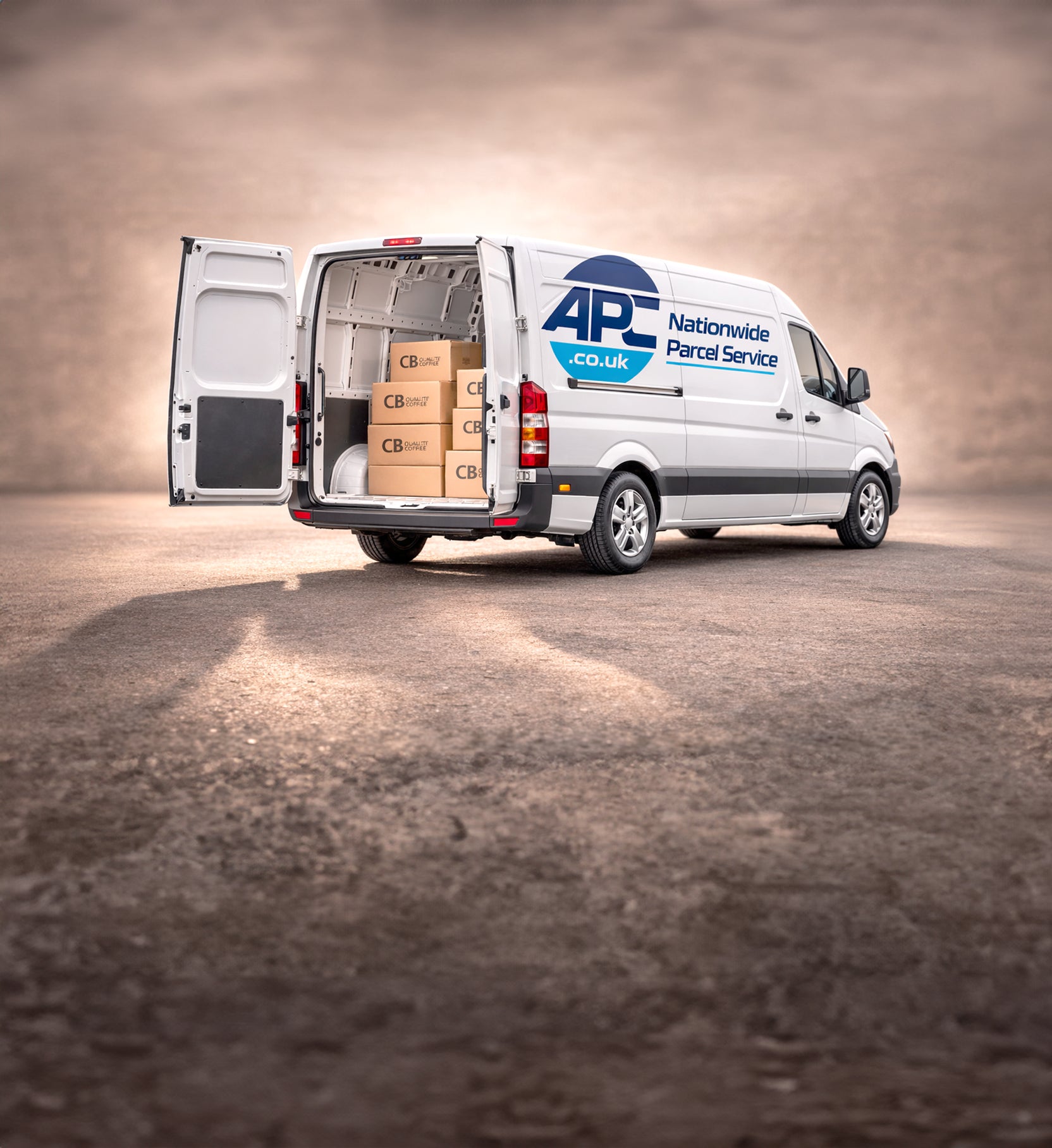White van with open back doors carrying cardboard boxes, branded as APC Nationwide Parcel Service.